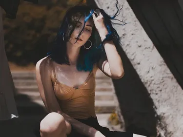 Blue Haired Woman Typing On Computer